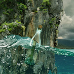 Message in a bottle flowing on waves. Fake underwater effect